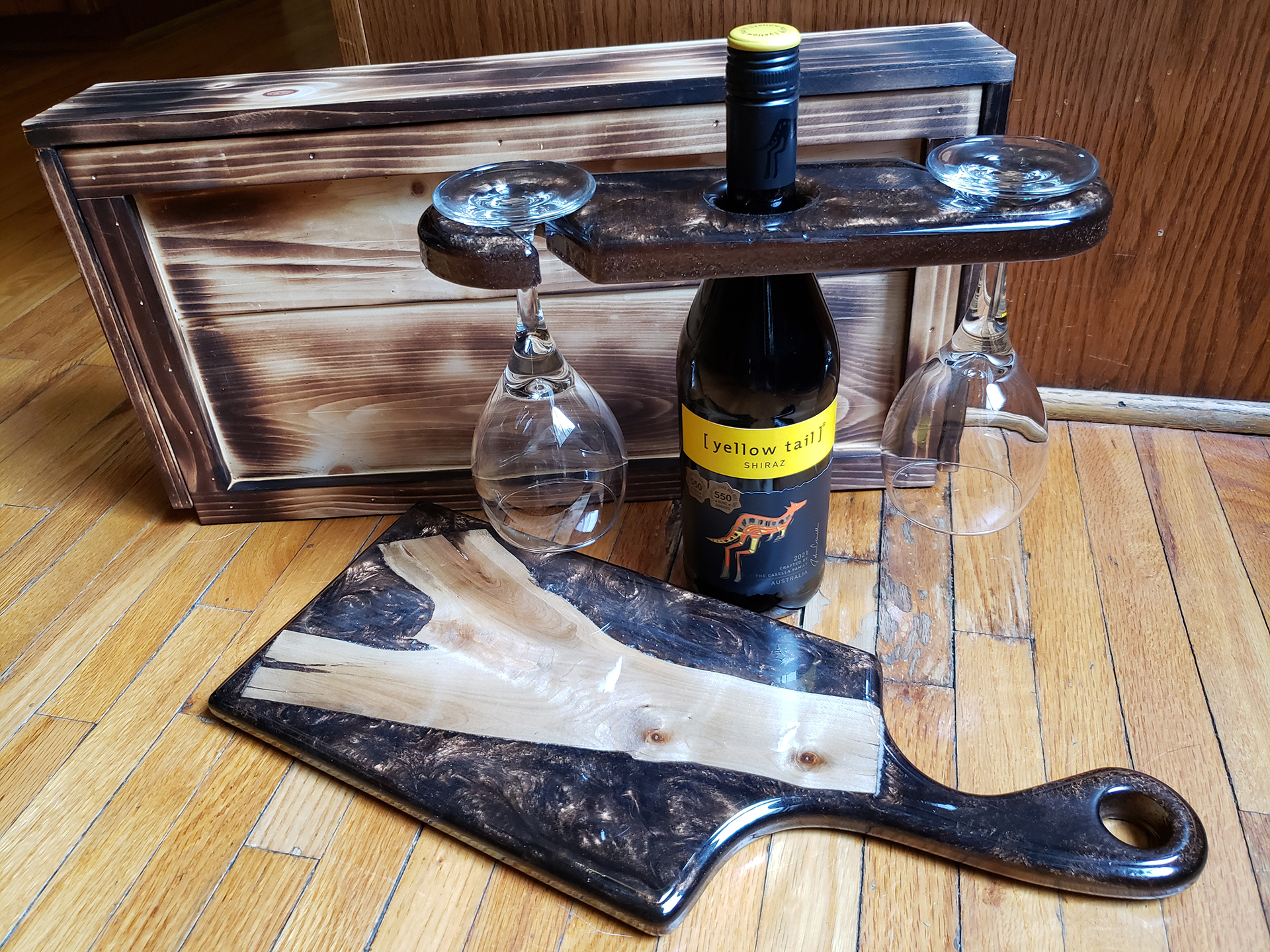 A win glass holder and cheese serving board with a nice rustic storage case